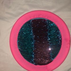 A pink and blue sequins frisbee
